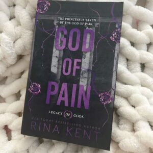 Cover of "God of Pain" by Rina Kent, featuring a dark, moody design with bold typography. The image evokes themes of obsession, emotional torment, and intense romance between a mafia princess and a brooding anti-hero.