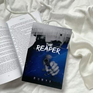 Book cover of The Reaper by RuNyx, featuring a dark, atmospheric design with stormy elements and bold typography. The imagery reflects the novel’s intense themes of mystery, romance, and emotional reckoning in a mafia setting
