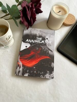 Book cover of "The Annihilator" by RuNyx, featuring a dark, atmospheric design with a shadowy male figure—The Shadow Man—standing against a backdrop of smoke and moonlight. His intense gaze and tailored suit evoke danger and obsession. The title appears in bold, metallic lettering, with the author's name below.